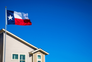 A Texas flag flies above a home, symbolizing our Groves home care services.