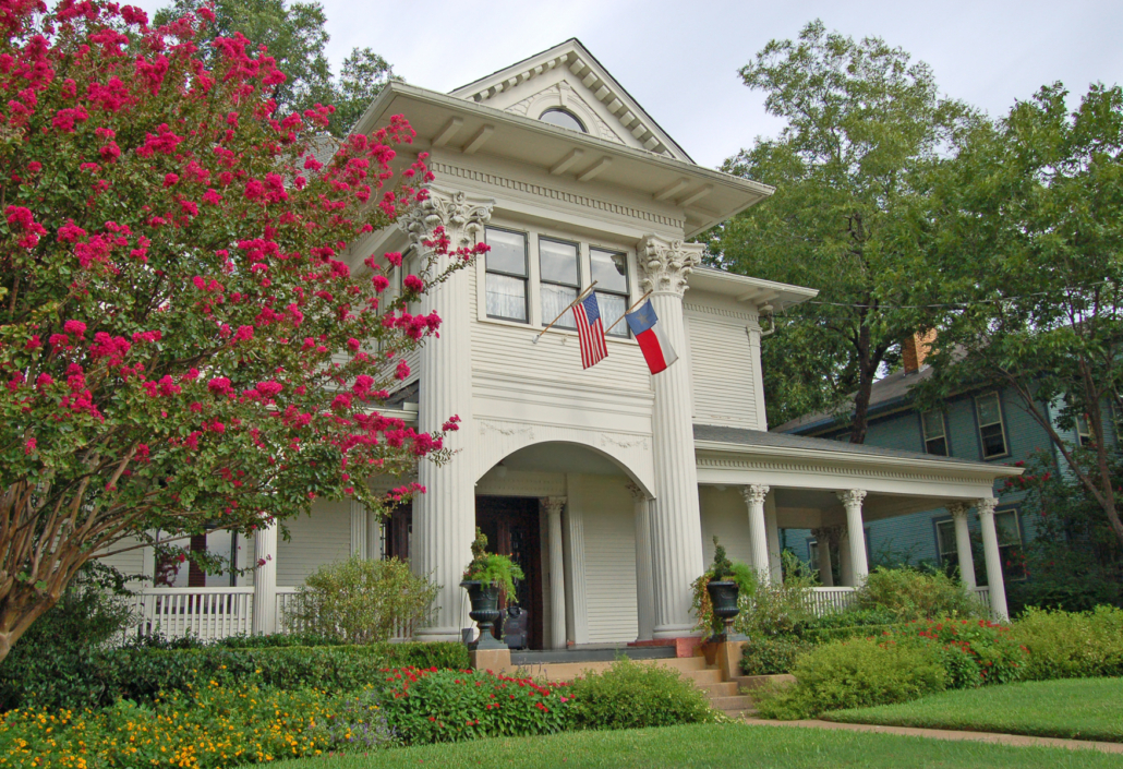 A stately house displays a Texas state flag, symbolizing our Nederland TX home care services.